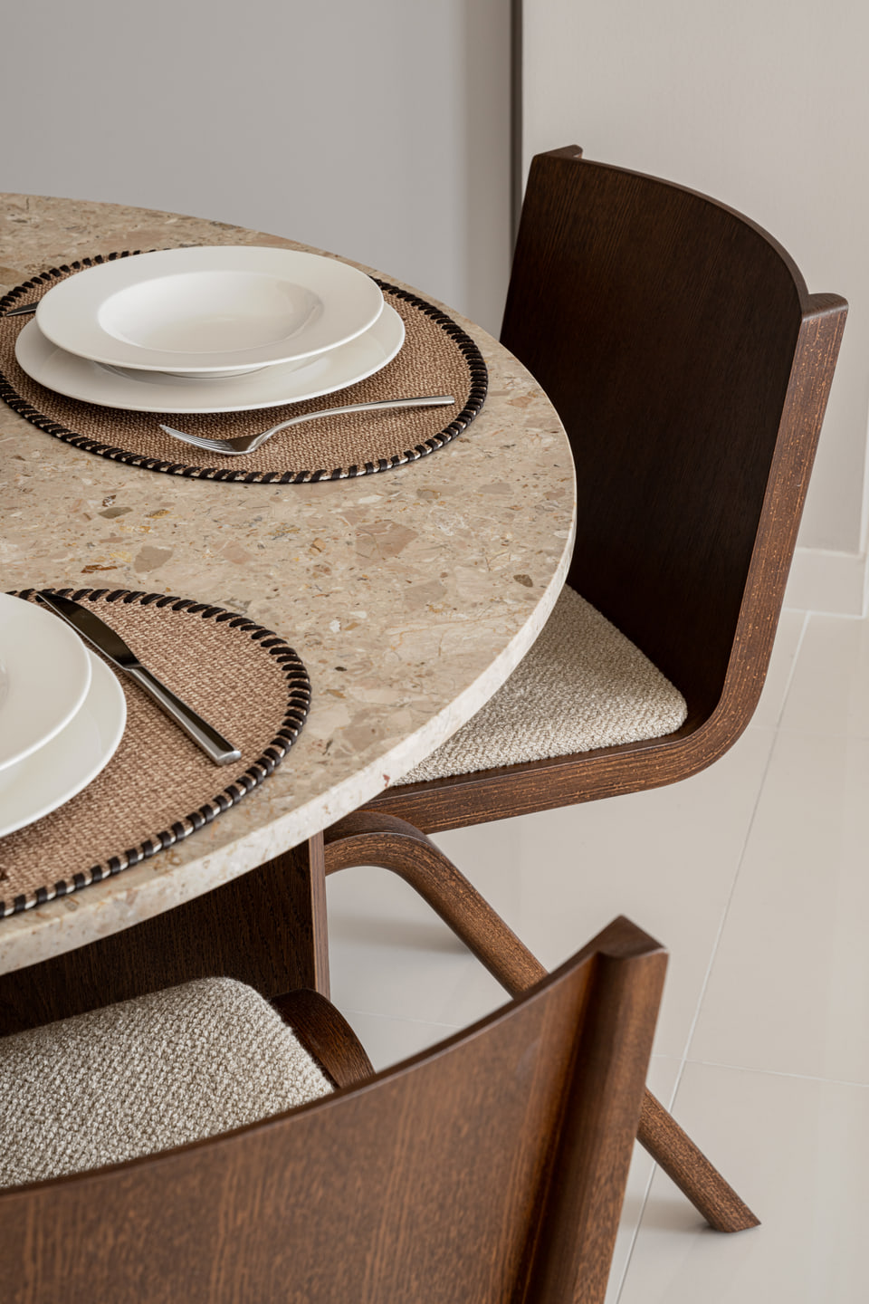 Round stone dining table set with dark timber chairs