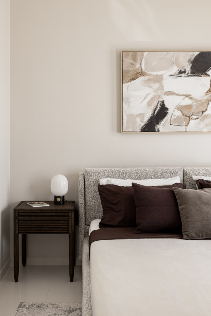 Bedside table, artwork and upholstered bed