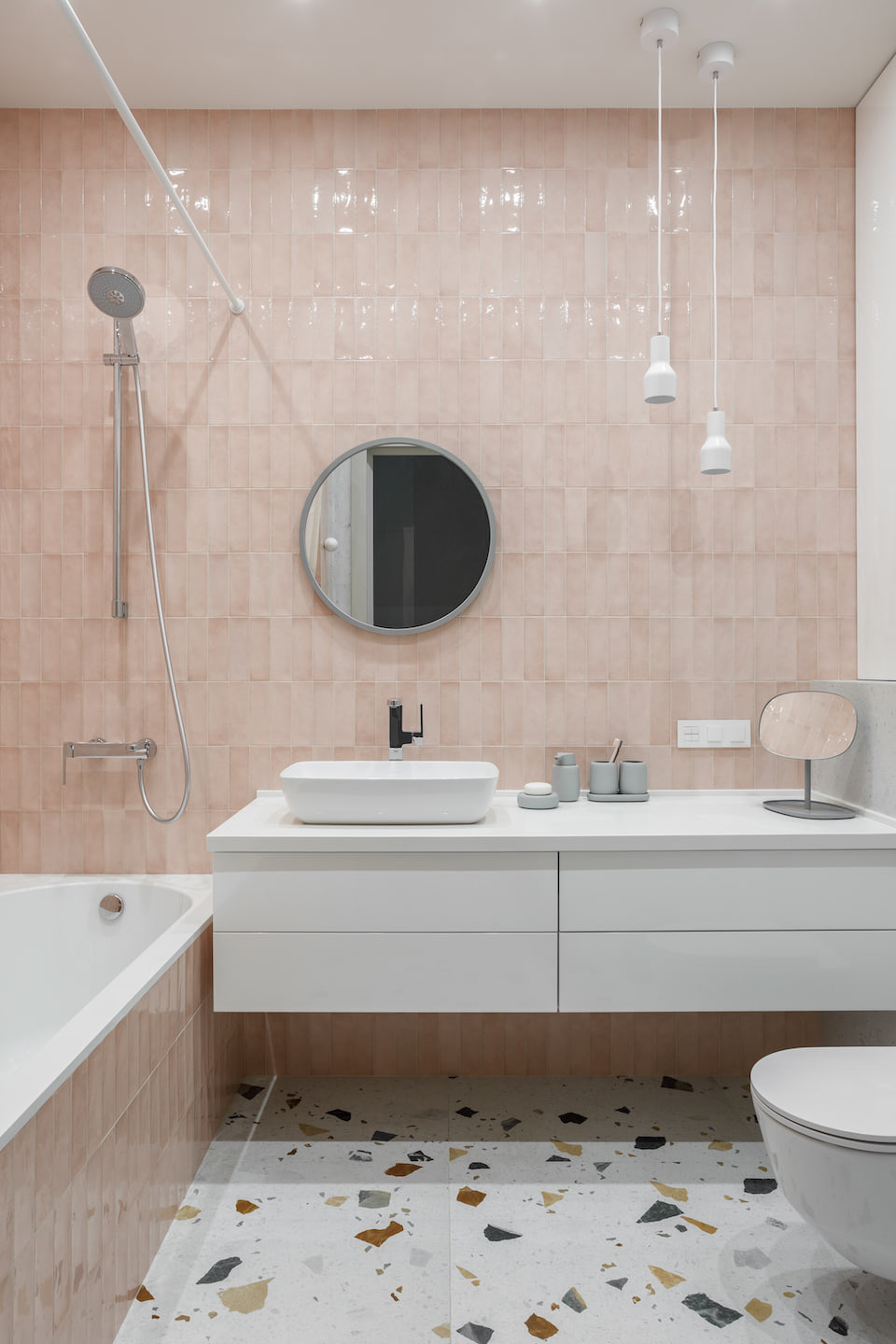 Bathroom with blush wall tiles and patterned floor