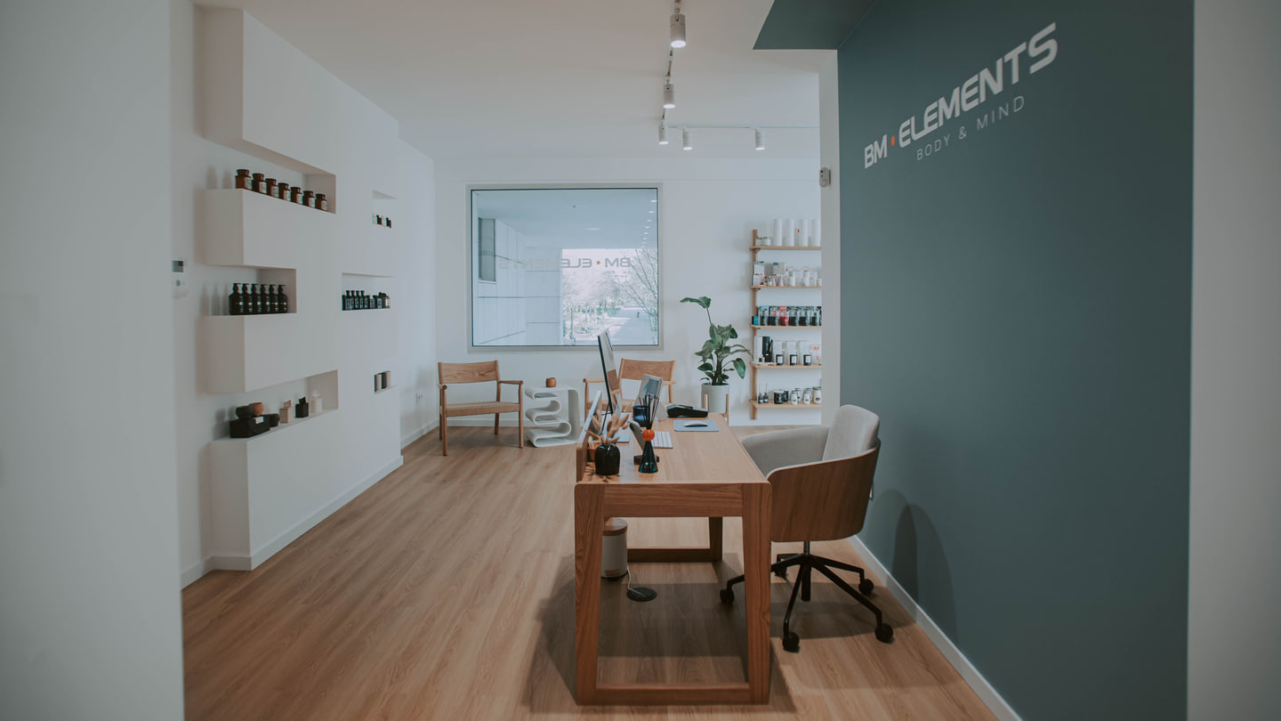 Porto wellness studio with pale timber floor and muted green wall