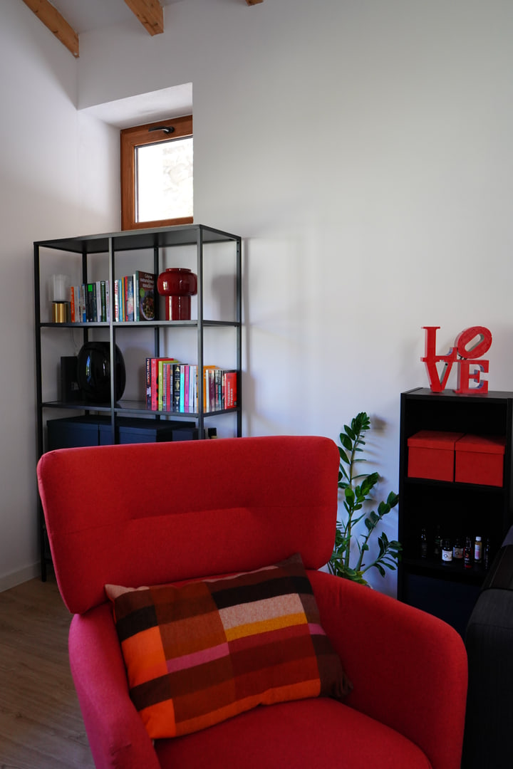 Red armchair and graphic accessories in the living space