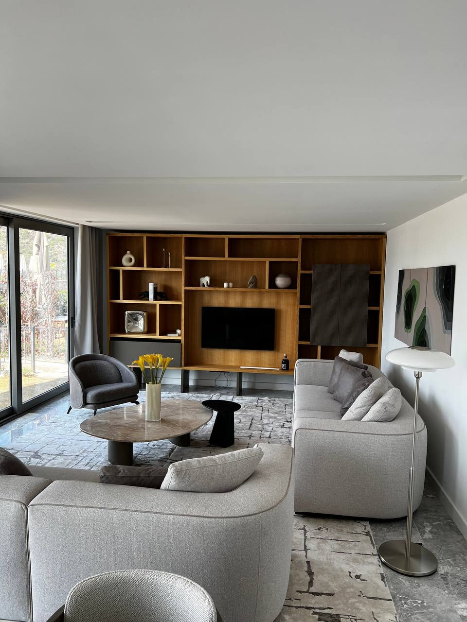 Bodrum villa living room with pale curved seating and dark timber joinery
