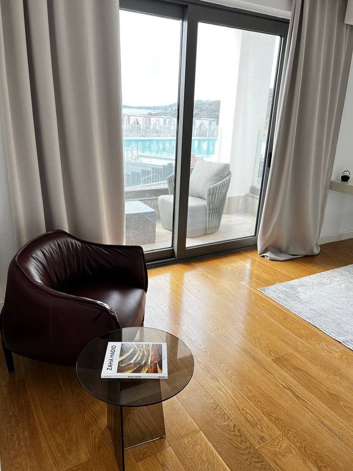 Burgundy leather chair and glass side table beside terrace doors
