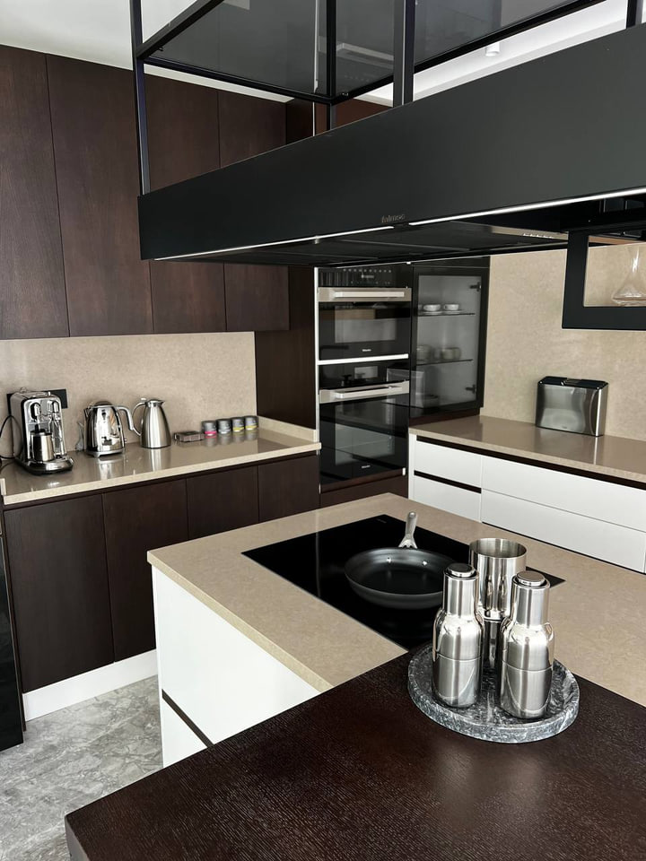 Villa kitchen with dark cabinetry and a pale island