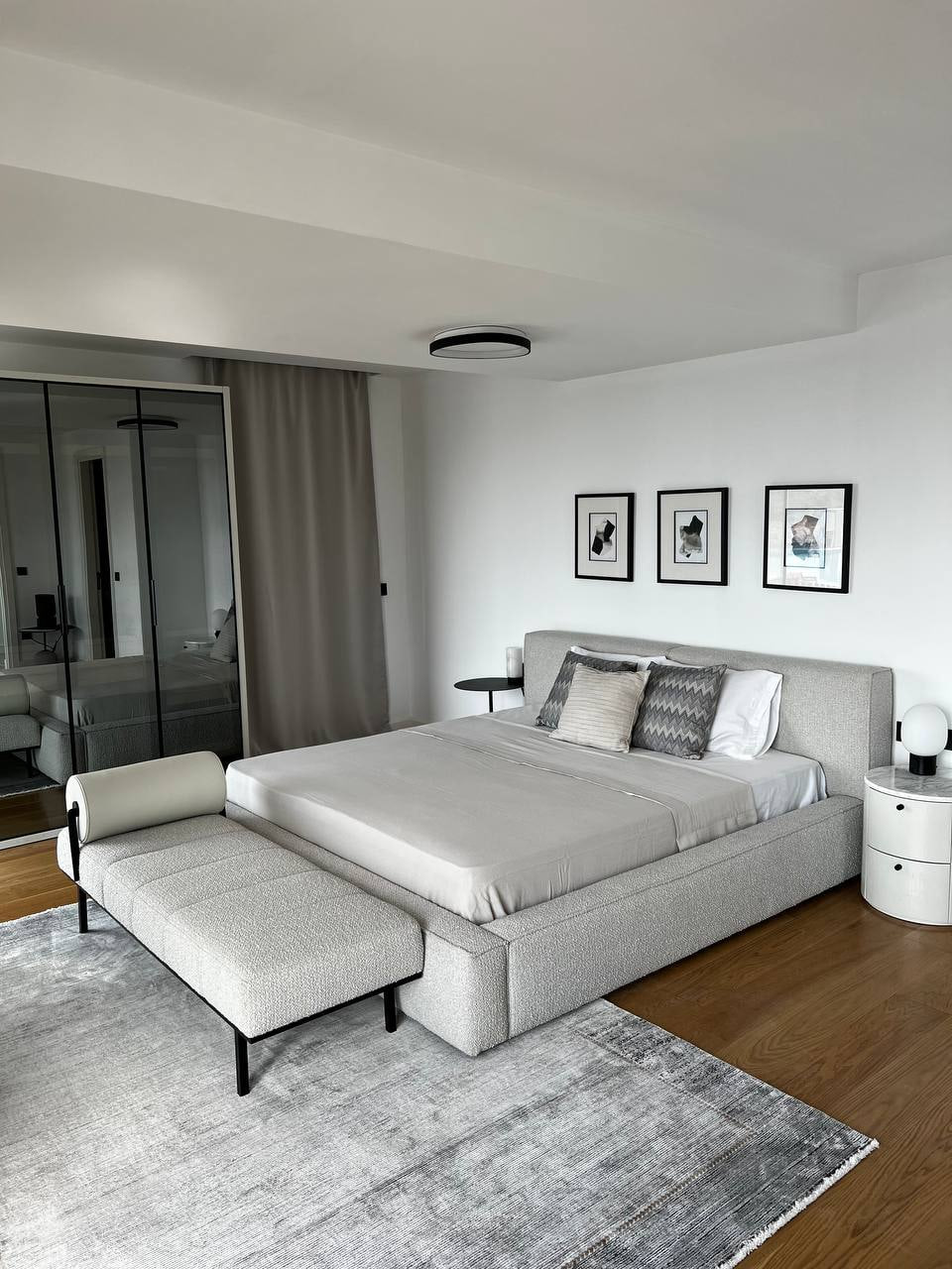 Living space with pale modular seating and timber media wall